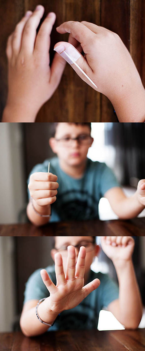 young boy performs magic trick