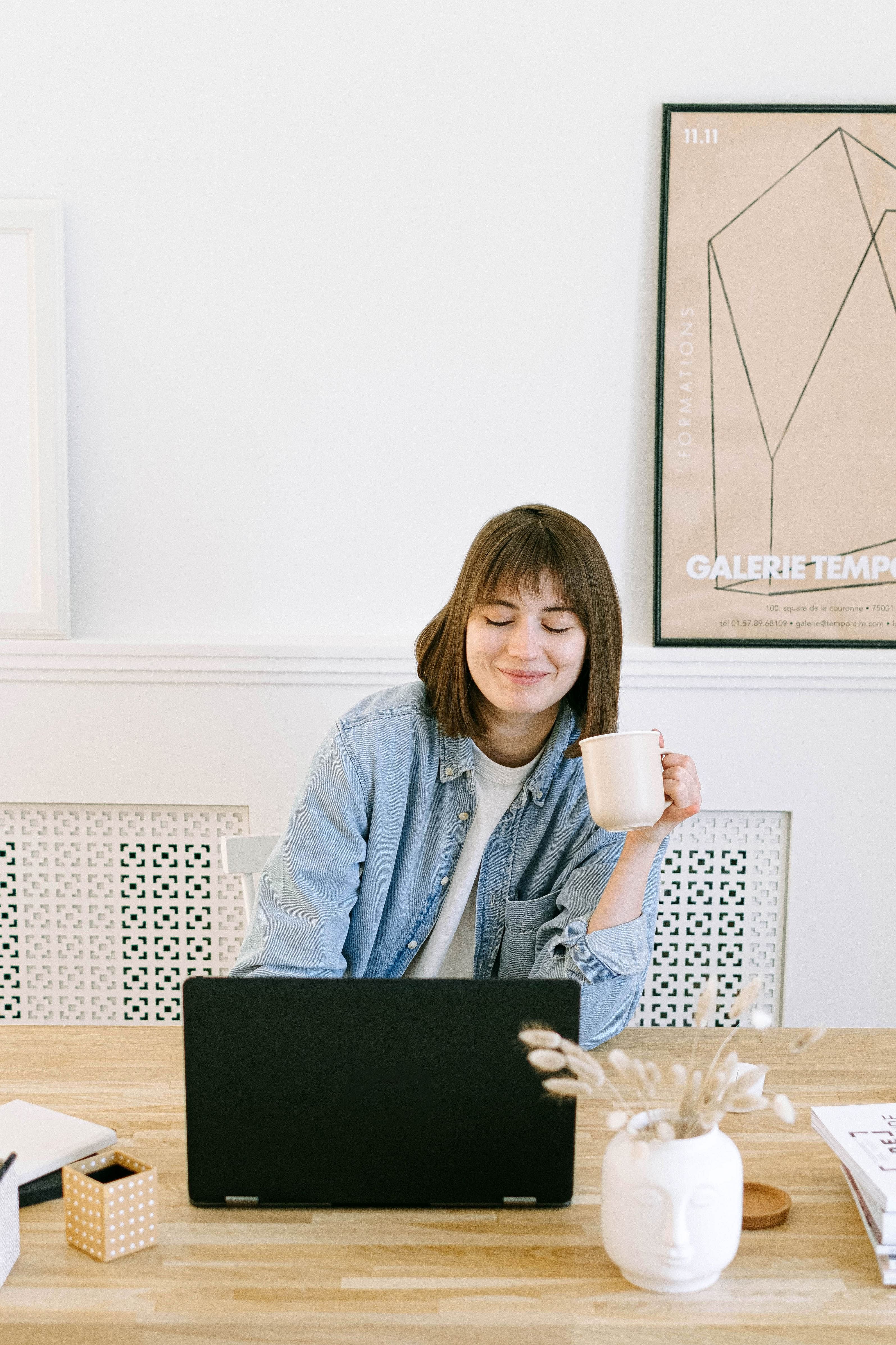 Woman checks email while drinking coffee