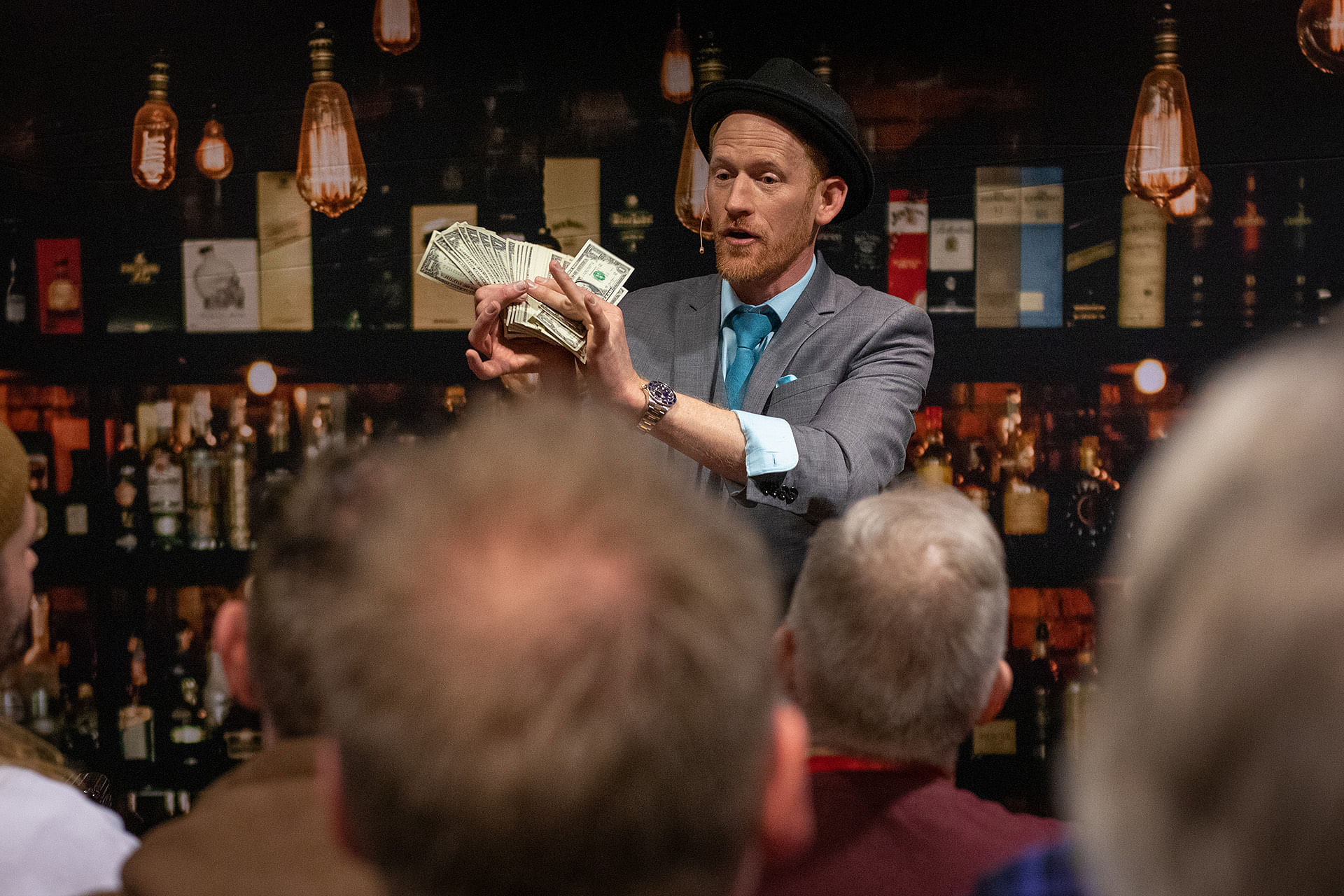 close-up magician Karl Hein performs a money magic trick at the magifest magic convention
