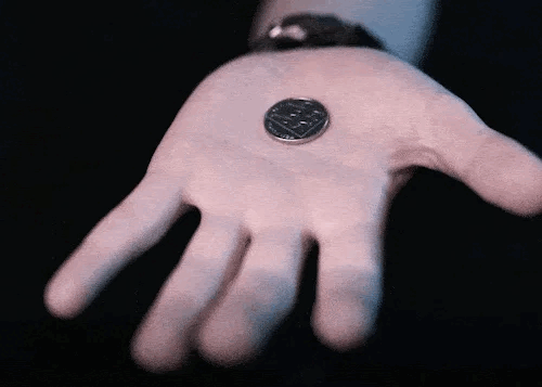 magician makes coin vanish