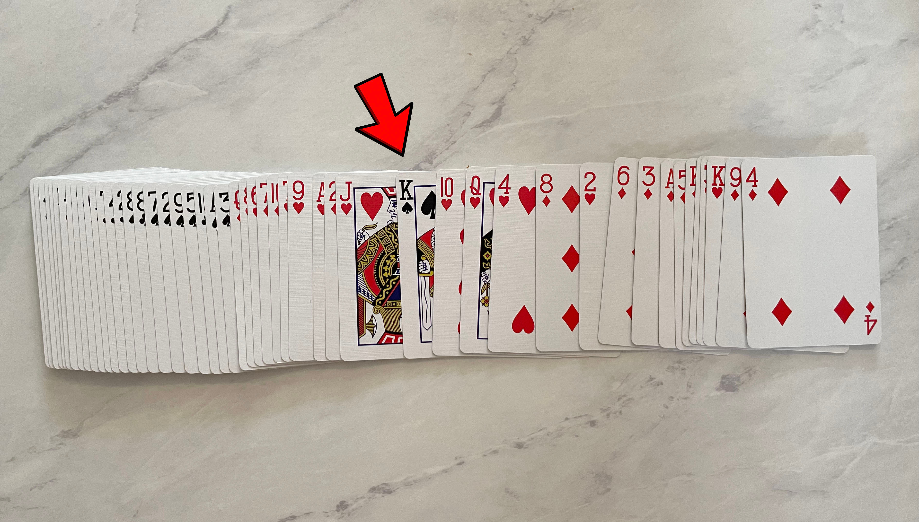 deck of cards fanned out and split into red and black cards