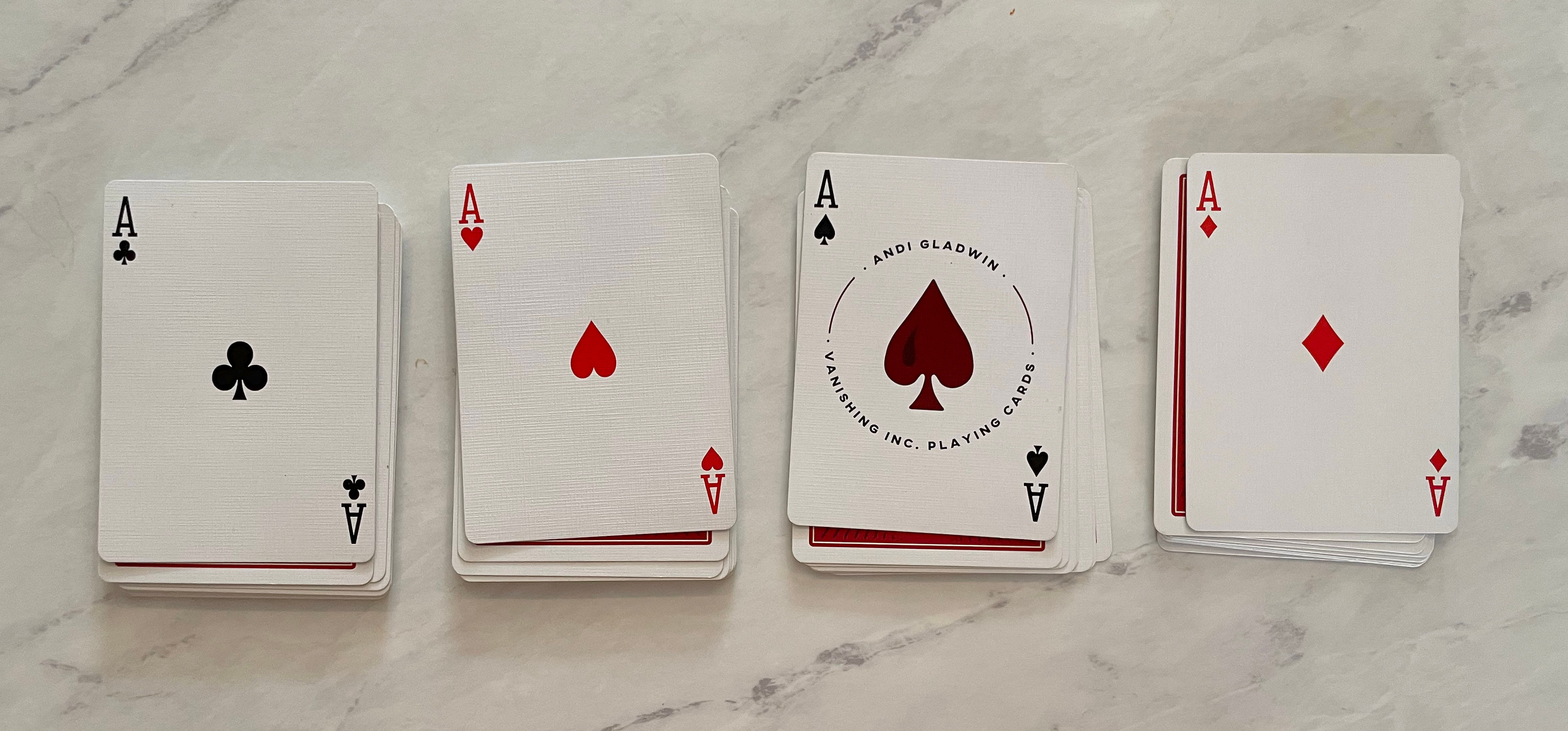 four aces on top of a deck of cards