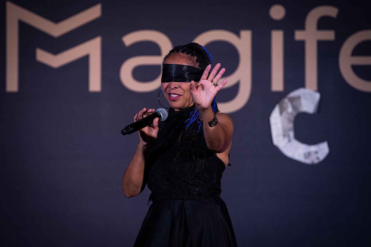black female magician tessa evason of The Evasons is blindfolded on stage