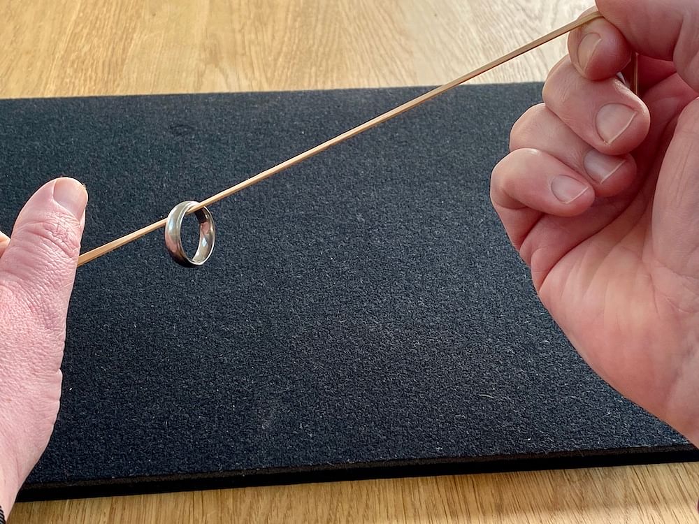 A ring travelling up a string impossibly