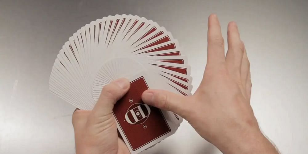 Dan and Dave Buck perform a basic thumb fan with a deck of cards