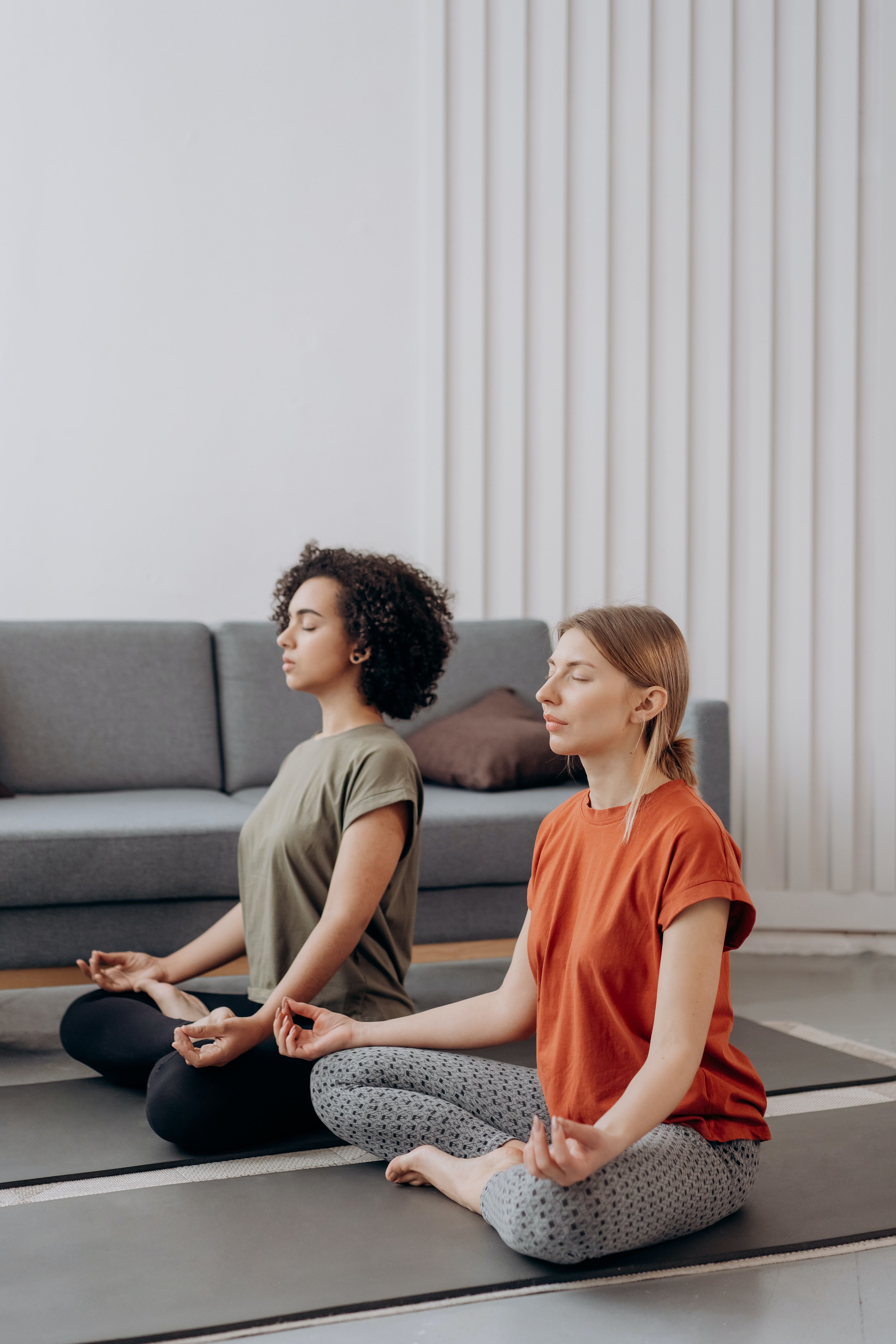 Two woman meditate while mindfulness training