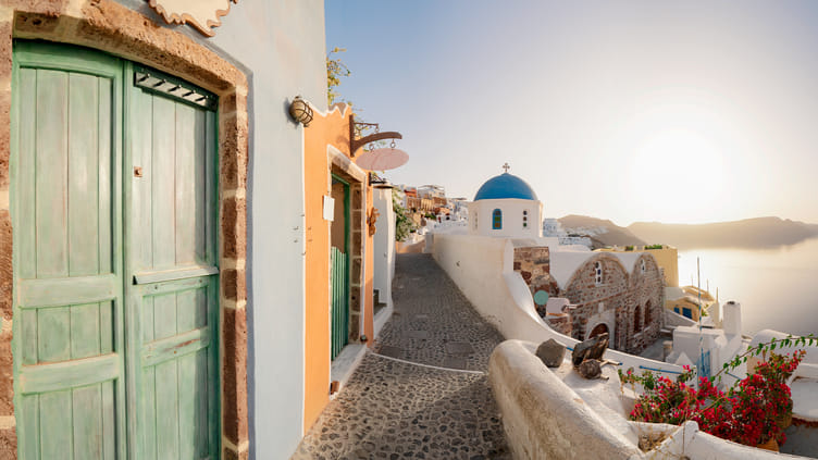 Stunning Santorini sunset over the caldera with traditional architecture