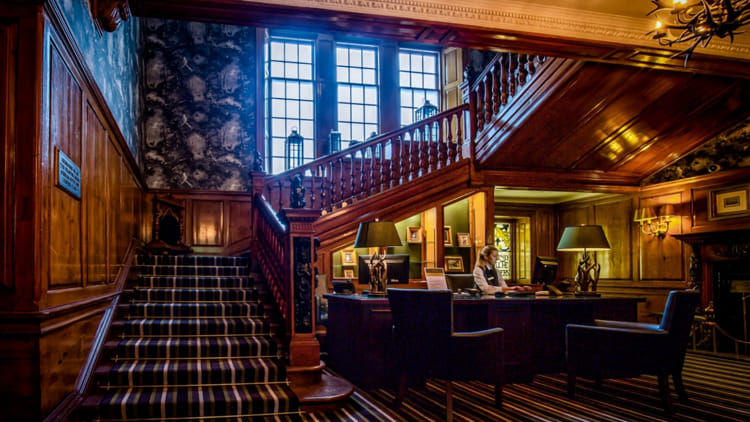 The grand wood-panelled interior of Dunkeld House Hotel